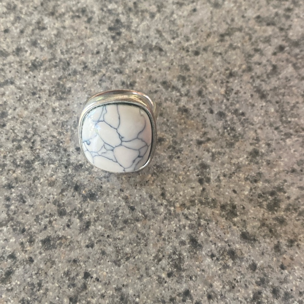 A silver with a marbled stone ring